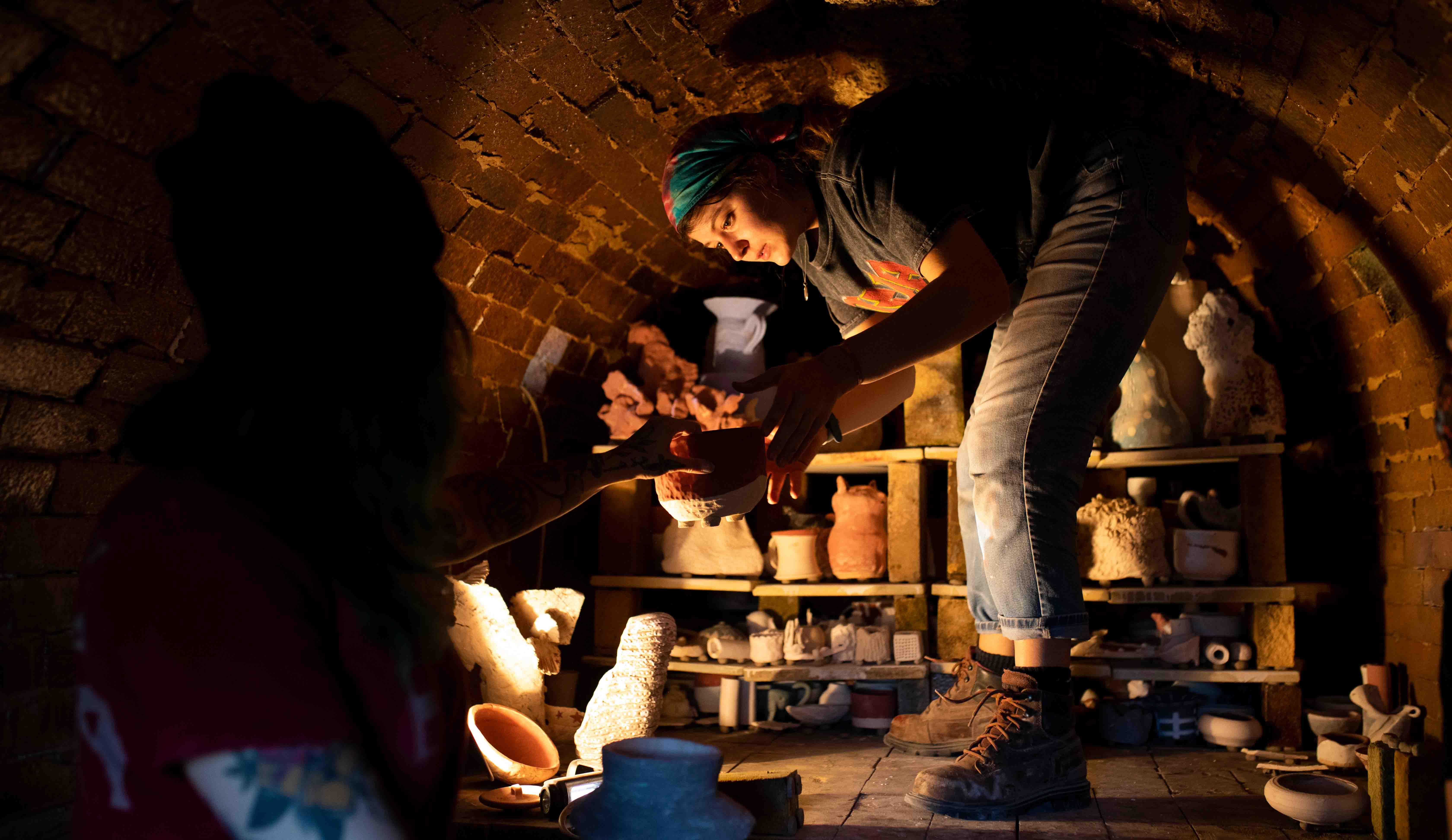 Students load the Anagama Kiln outside the Visual Arts Building