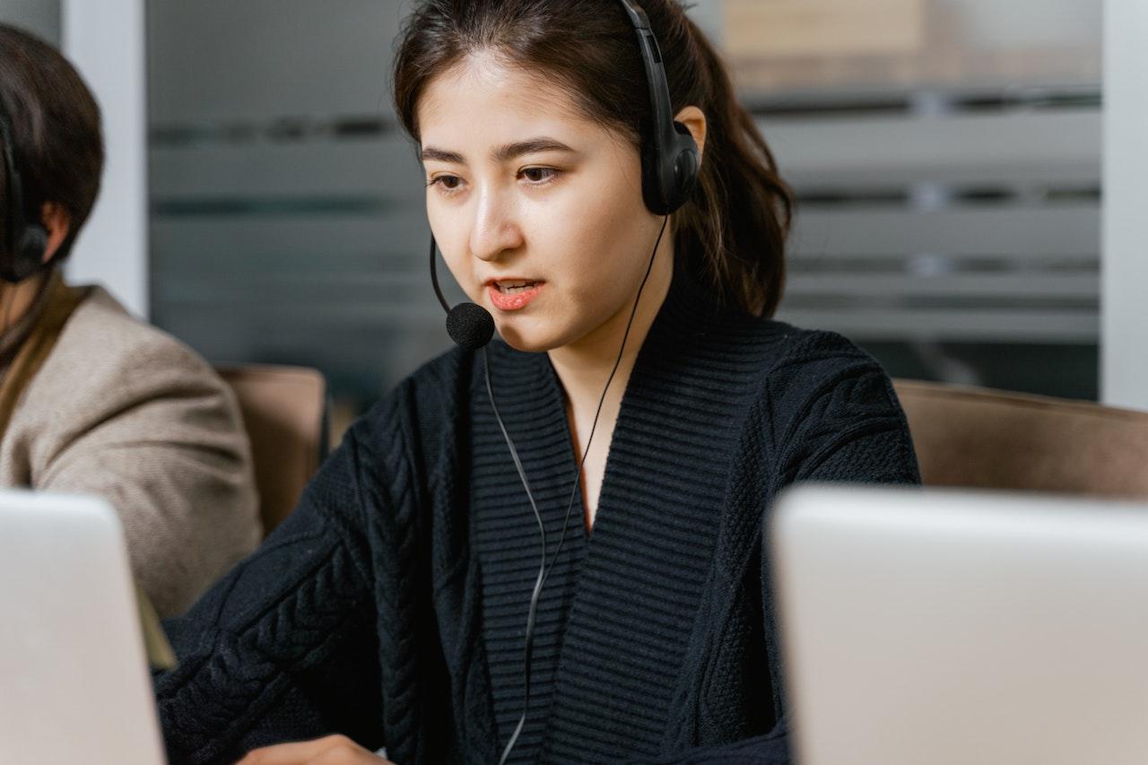 Woman Wearing Black Headset While Working