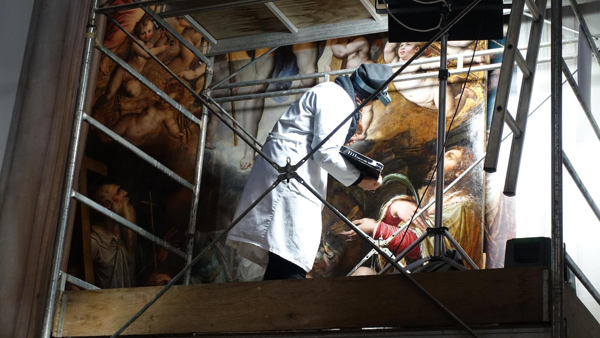 Restorer working on a mural