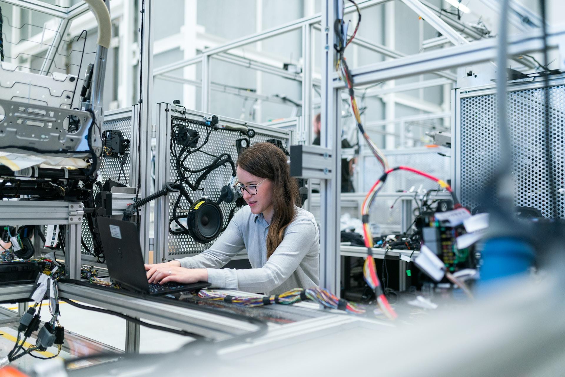 Photo Of Female Engineer Working On Her Workspace