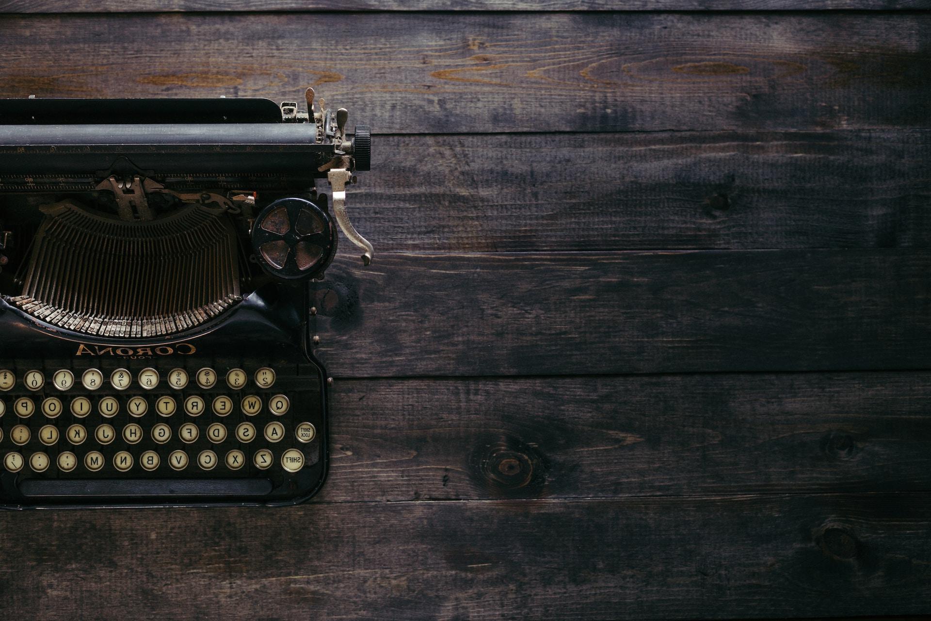 Typewriter sitting on a wooden table