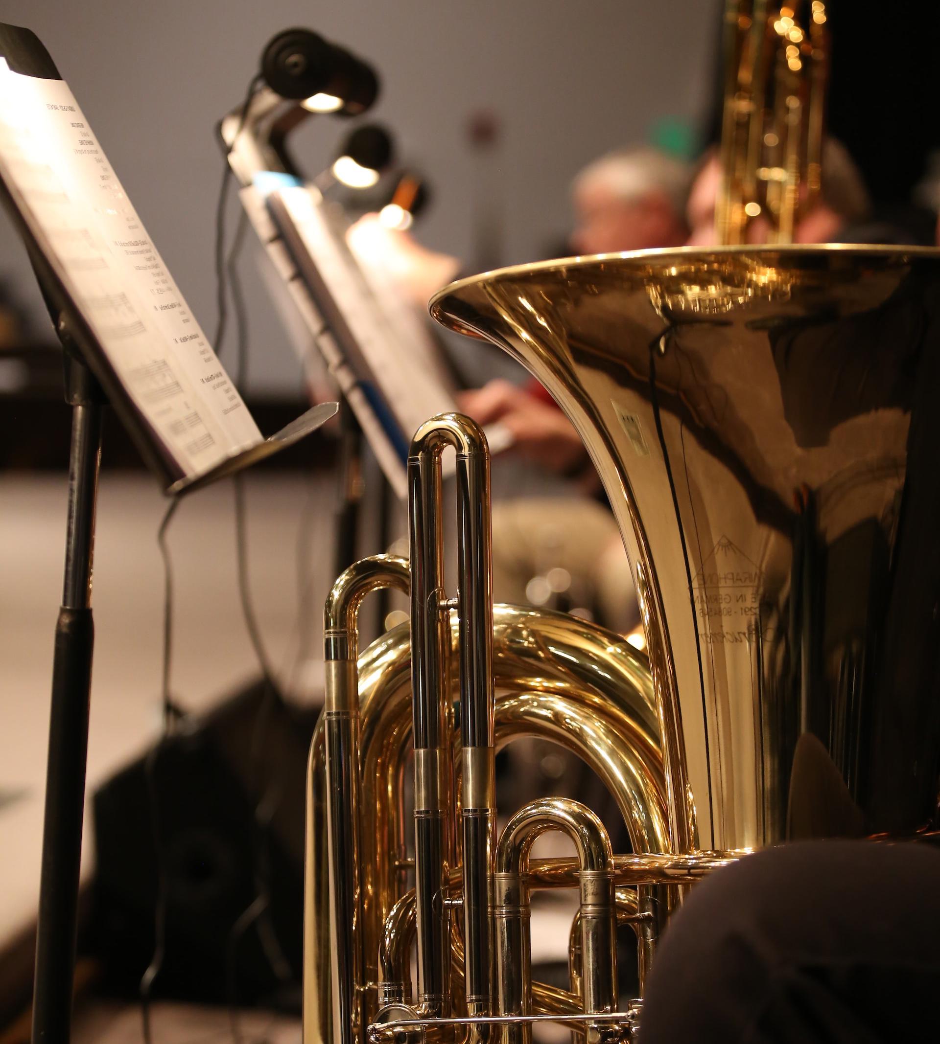 brass trumpet near white printer paper